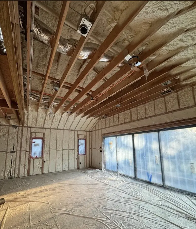 Interior walls and ceiling insulated with spray foam during new construction in Milltown